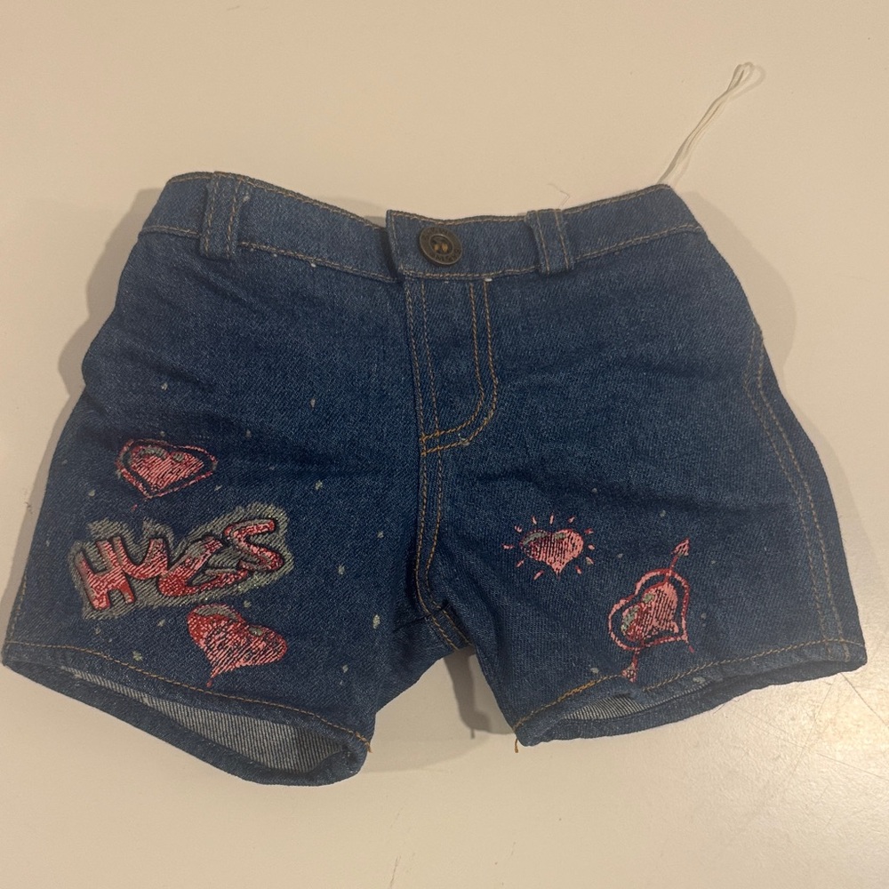 Build-A-Bear Workshop denim blue jeans featuring heart and hug designs